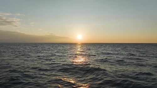 Aerial Video Sunset Rays Reflecting on the Textured Sea Surface Creating a Magical View