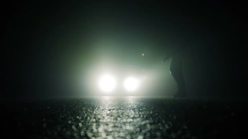 One Person Walking Alone on Street in Dark Night
