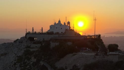 Orthodox church on Lycabettus Hill in Athens, Greece at a sunset