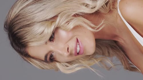 Studio Portrait of Young and Beautiful Blond Woman Over Grey Background Skin Care and Wellness