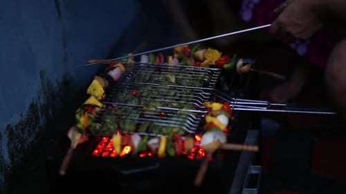 Grilled Vegetable Skewers on a Glowing Barbecue at Night