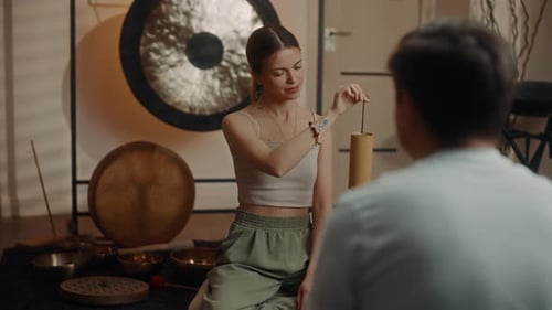 Sound Healer Playing Wind Chime During Therapy Session