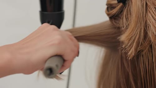 Hair Stylist Blow Drying and Styling Wet Hair