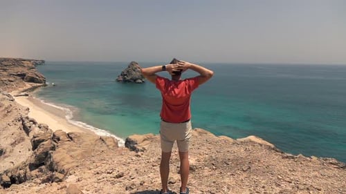 Man Stretching Arms and Admire Amazing Ocean View on Cliff, Super Slow