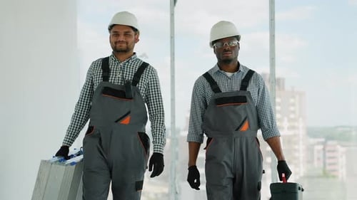 Construction Workers Carrying Tools in Urban Interior
