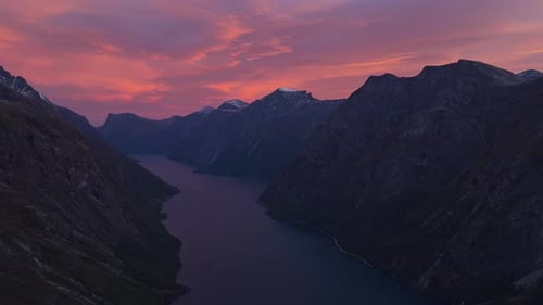 Drone view of Eikesdalsvatnet lake surrounded by rugged peaks in Norway