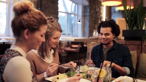 Friends eating together in a modern restaurant