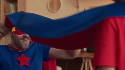 Father and Child Playing Superheroes in Living Room