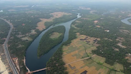 Aerial drone shot of Maravanthe Beach, showcasing the parallel highway and the Souparnika River.
