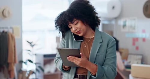 Woman Talking on Phone, Using Tablet in Office
