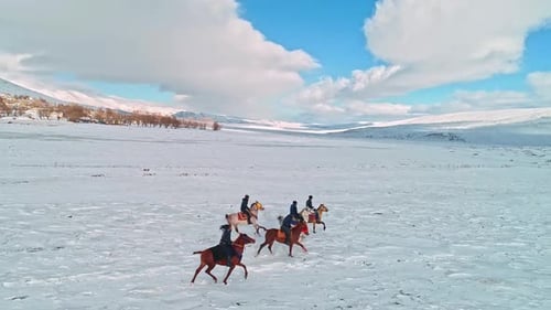 Horse Riders Galloping Through Snowy Winter Landscape