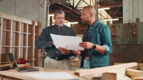 Carpentry, workshop and men with blueprints for woodwork, furniture restoration and teamwork
