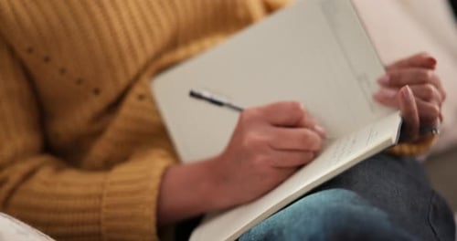 Woman Writes in Notebook at Home Close Up