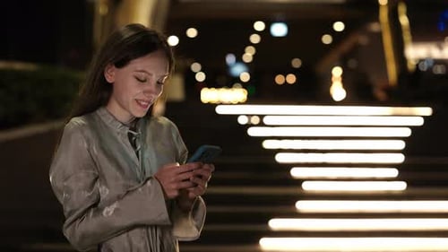 Cute Young Student Texting with Teacher Standing Outside in Night City Street