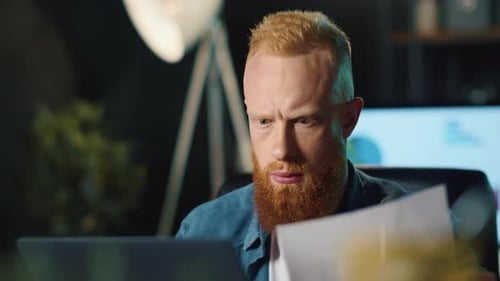Portrait Of Pensive Business Man Checking Data In Office. Bearded Hipster Guy Working With Laptop...