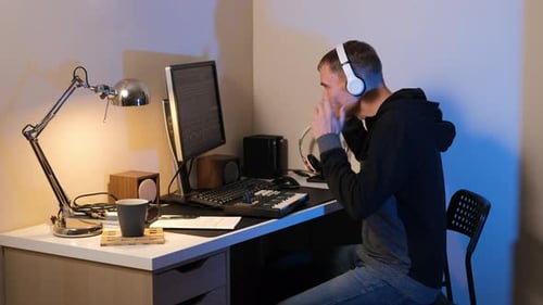 Young Musician Composing Tracks at a Home Studio