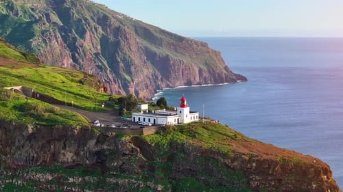 Stunning aerial view of a coastal lighthouse on a cliff overlooking the ocean