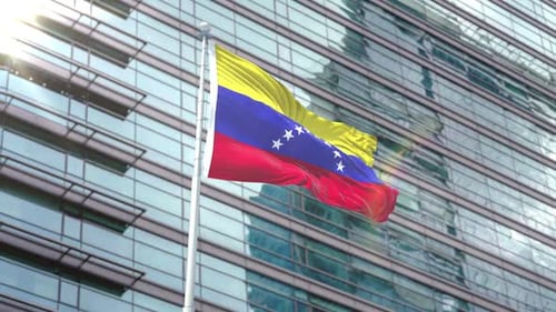 Venezuelan Flag Waving on a Modern Office Building Pole