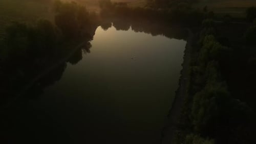 Swans on the lake at sunset. Sunset on the lake in the fields