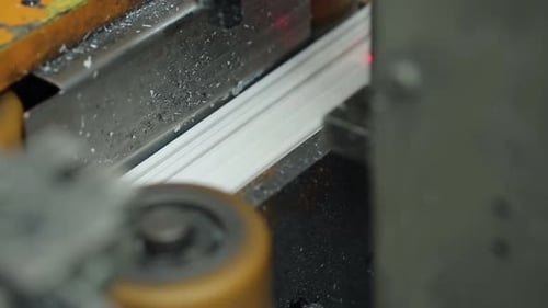 Machine cutting metal trim at factory, manufacturing process
