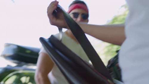 Friends packing bags into a van for a road trip