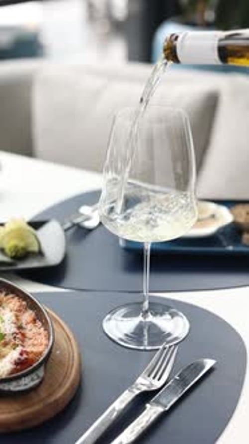 a glass of white wine in a restaurant