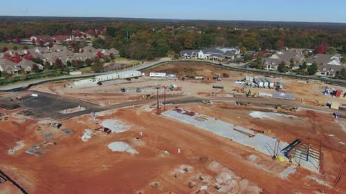 Luftaufnahme der Baustelle mit Vororten im Hintergrund