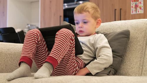 Child Playing on Tablet at Home