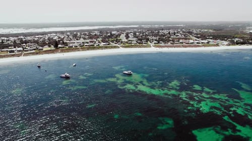 Fishing boats glides near the shoreline