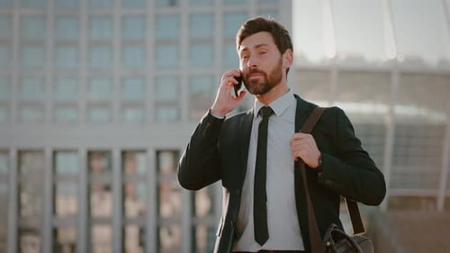 Successful Businessman Speaks with Client on Phone By Office
