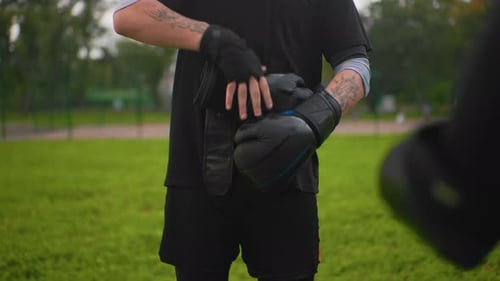Man Prepares for Boxing Training in the Park