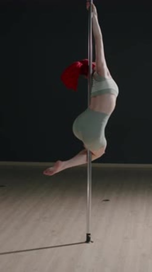 Red Haired Girl Spinning on Pole in Studio