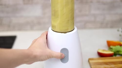 Hand Blending Smoothie in Kitchen Blender