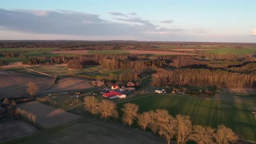 Countryside aerial footage with green fields and cottages. Spring time.