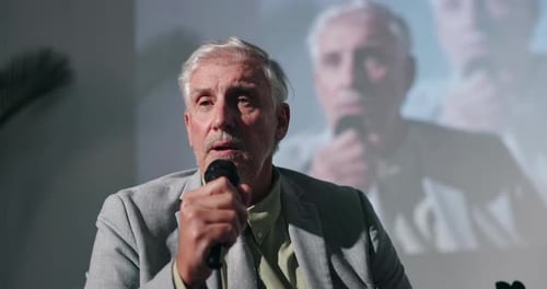 Man Speaking Into Microphone at Corporate Event