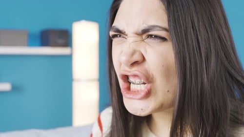Woman With Braces Expressing Frustration