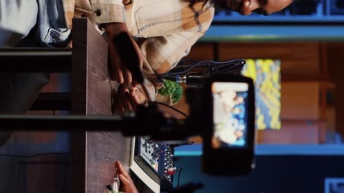 Person recording video on smartphone with microphone