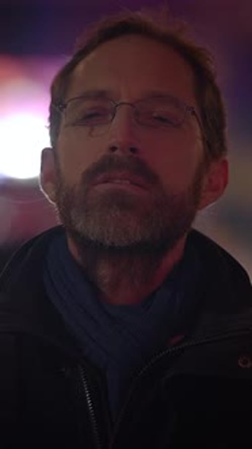 Man with Glasses Looks Directly into the Camera