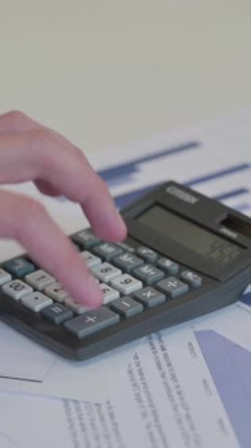 Close up of Middle Aged Businessman making Calculations, Vertical Video