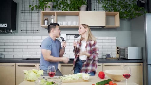 Couple Singing and Dancing in a Modern Kitchen