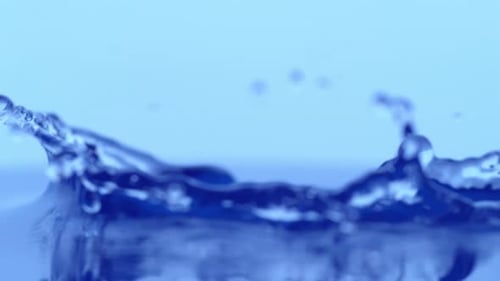 Water Drop Splash in Slow Motion on Blue
