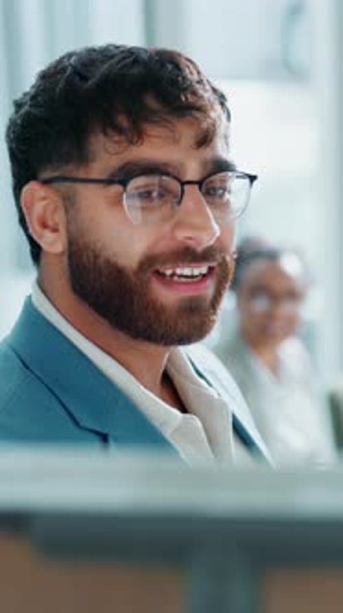 Young Man in Business Meeting Turns and Smiles