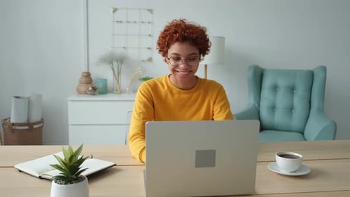 African American Girl Using Laptop at Home Office Looking at Screen Typing Chatting Reading Writing