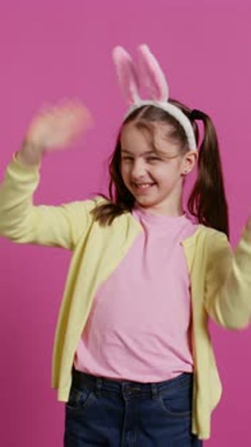 Happy Girl Waving Wearing Bunny Ears