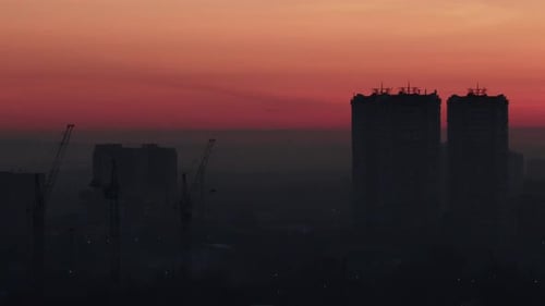 Silhouette of City Buildings at Sunrise