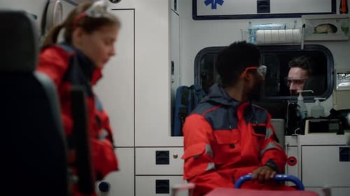 African american doctor talks with ambulance driver on emergency rescue night shift