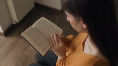 Devotional Hands Reading a Bible Symbolizing Faith and Worship