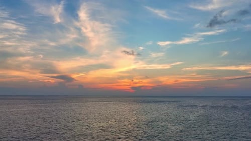 Aerial view drone flying over sea waves during sunset. 4K.