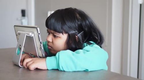 Young Child Using Tablet Device Indoors