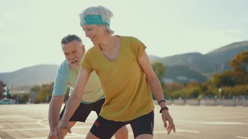 Active Mature Couple Playing Basketball Outdoors